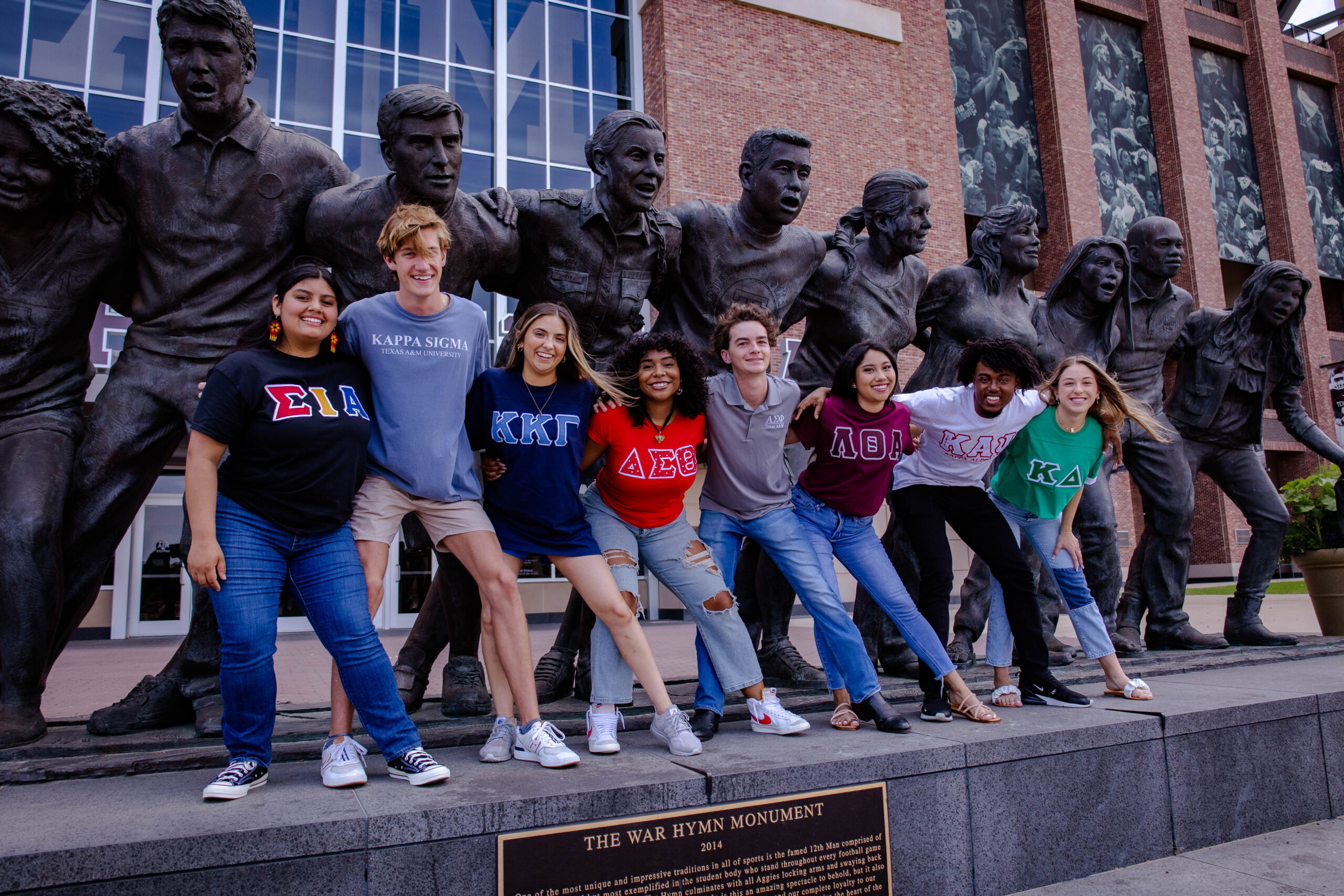 Greek students swaying in front of the War Hymn statue proudly wearing their letters.